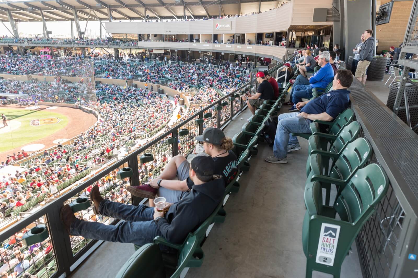 Visitors watch a ball game at Salt River Fields.